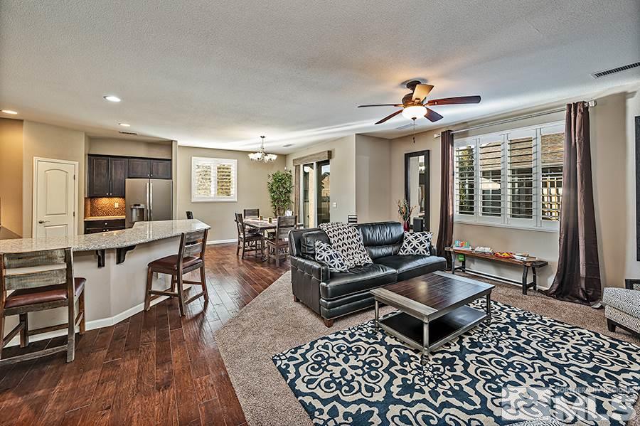 2201 Dominic Drive Reno, NV 89521 - Photo 8 of 20 a living room with furniture a flat screen tv and a table