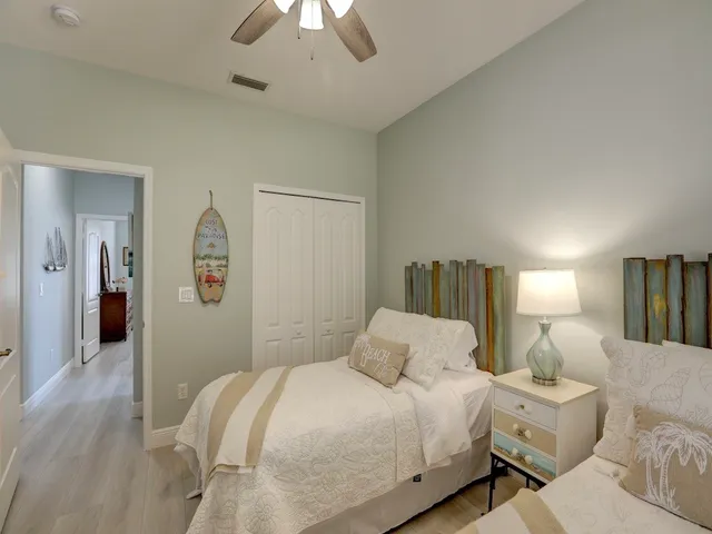 a bedroom with bed and a chandelier