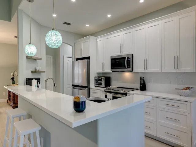 a kitchen with cabinets and stainless steel appliances