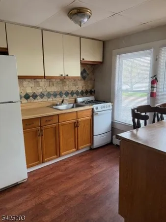 an empty room with fireplace and windows