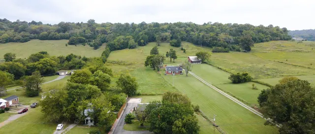 a kitchen with granite countertop a refrigerator sink and cabinets