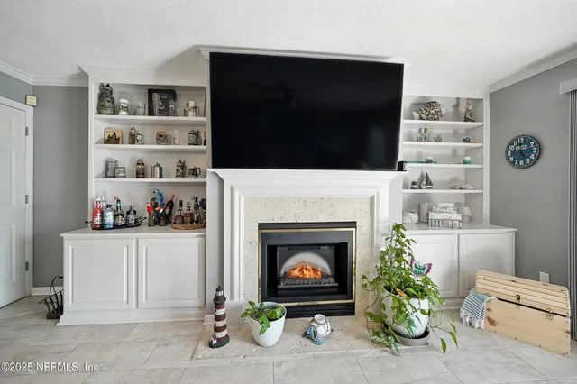 a living room with furniture a fireplace and a flat screen tv