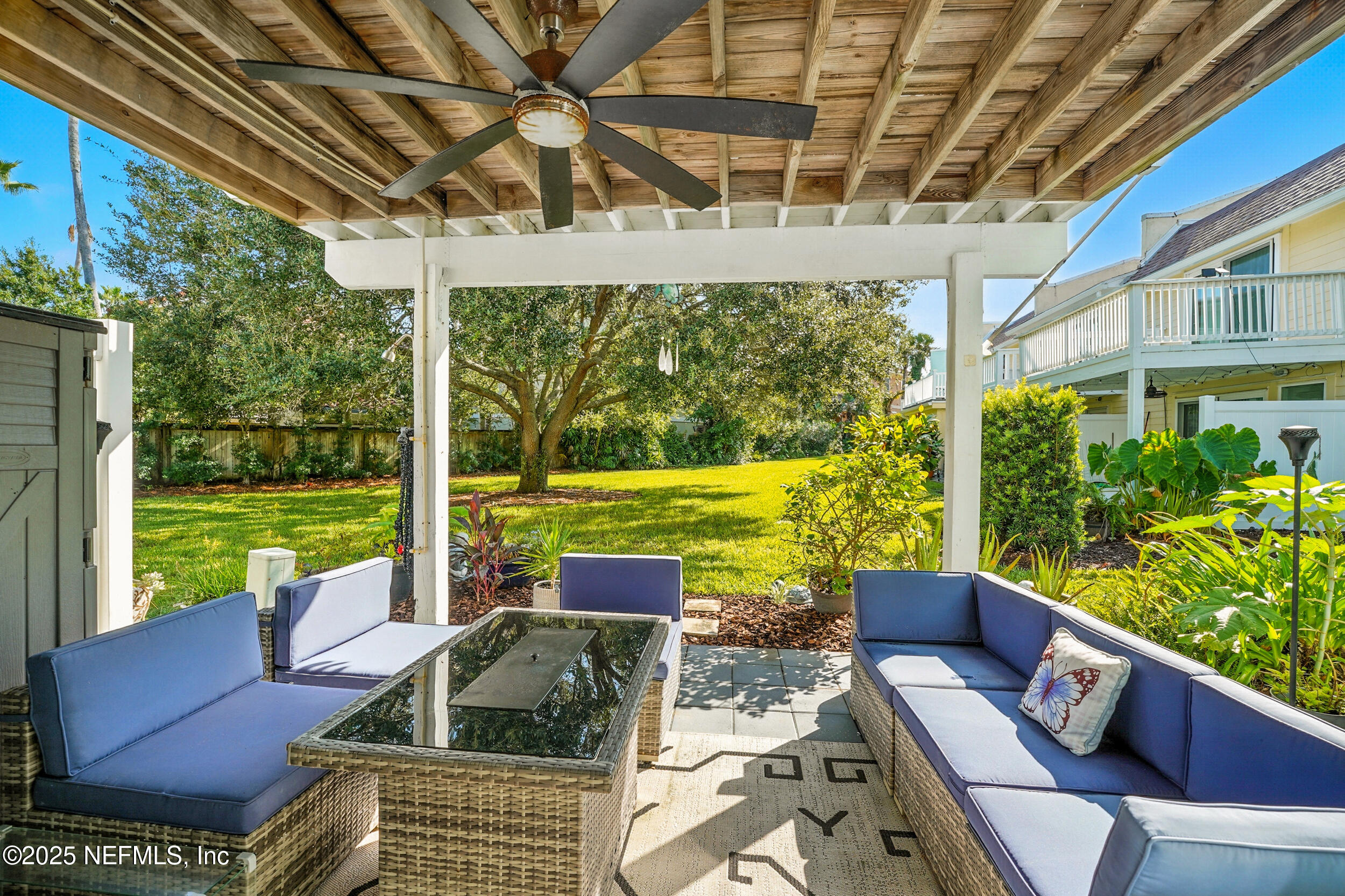 2233 Seminole Road, Unit 3 Atlantic Beach, FL 32233 - Photo 17 of 59 a view of a patio with couches chairs potted plants and floor to ceiling window with yard