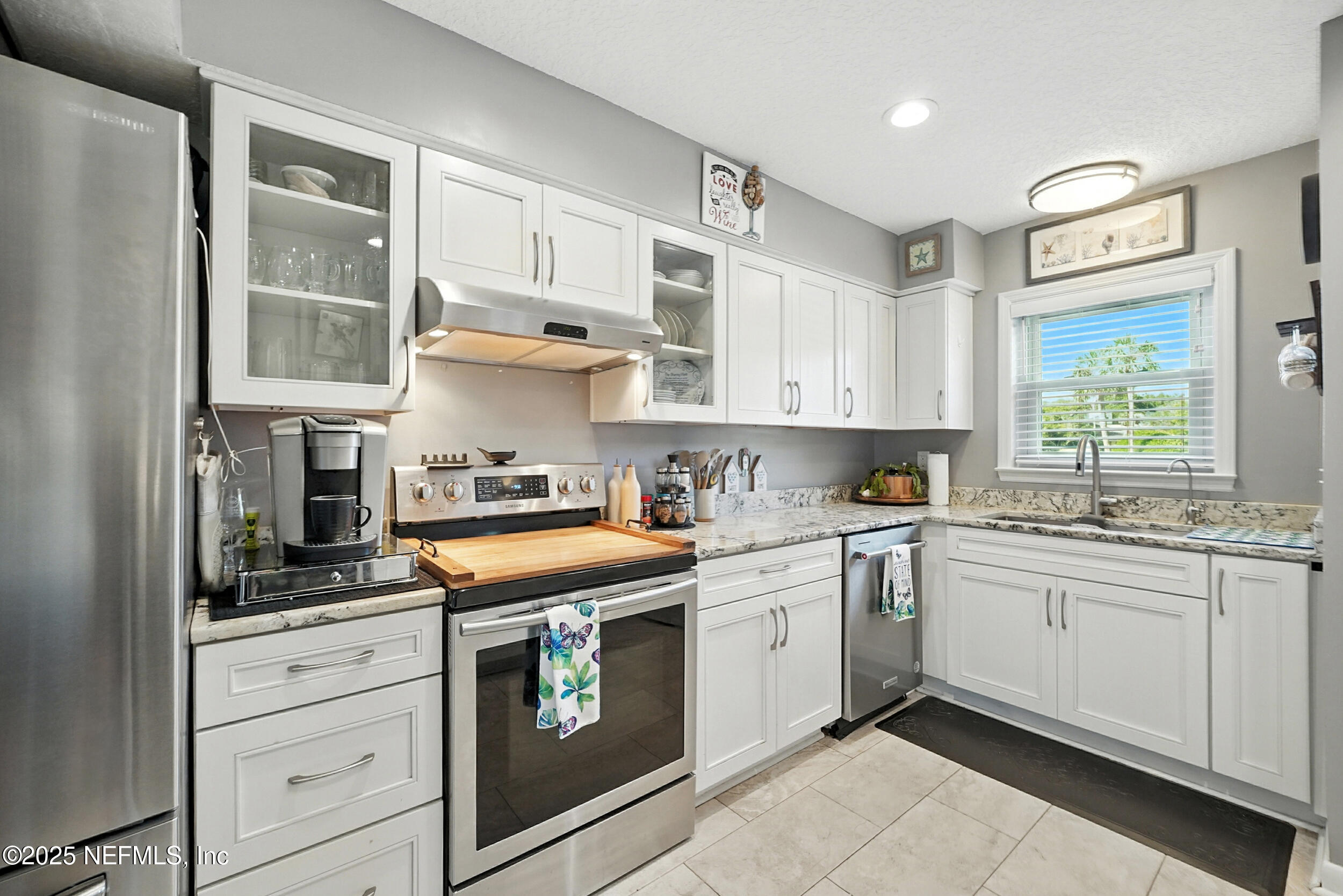 2233 Seminole Road, Unit 3 Atlantic Beach, FL 32233 - Photo 23 of 59 a kitchen with stainless steel appliances granite countertop a sink and cabinets