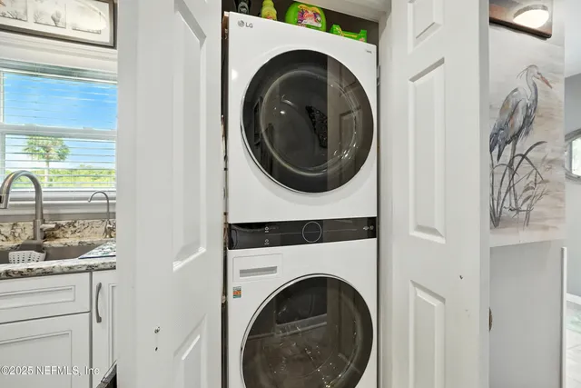 a view of staircase with white walls and a mirror
