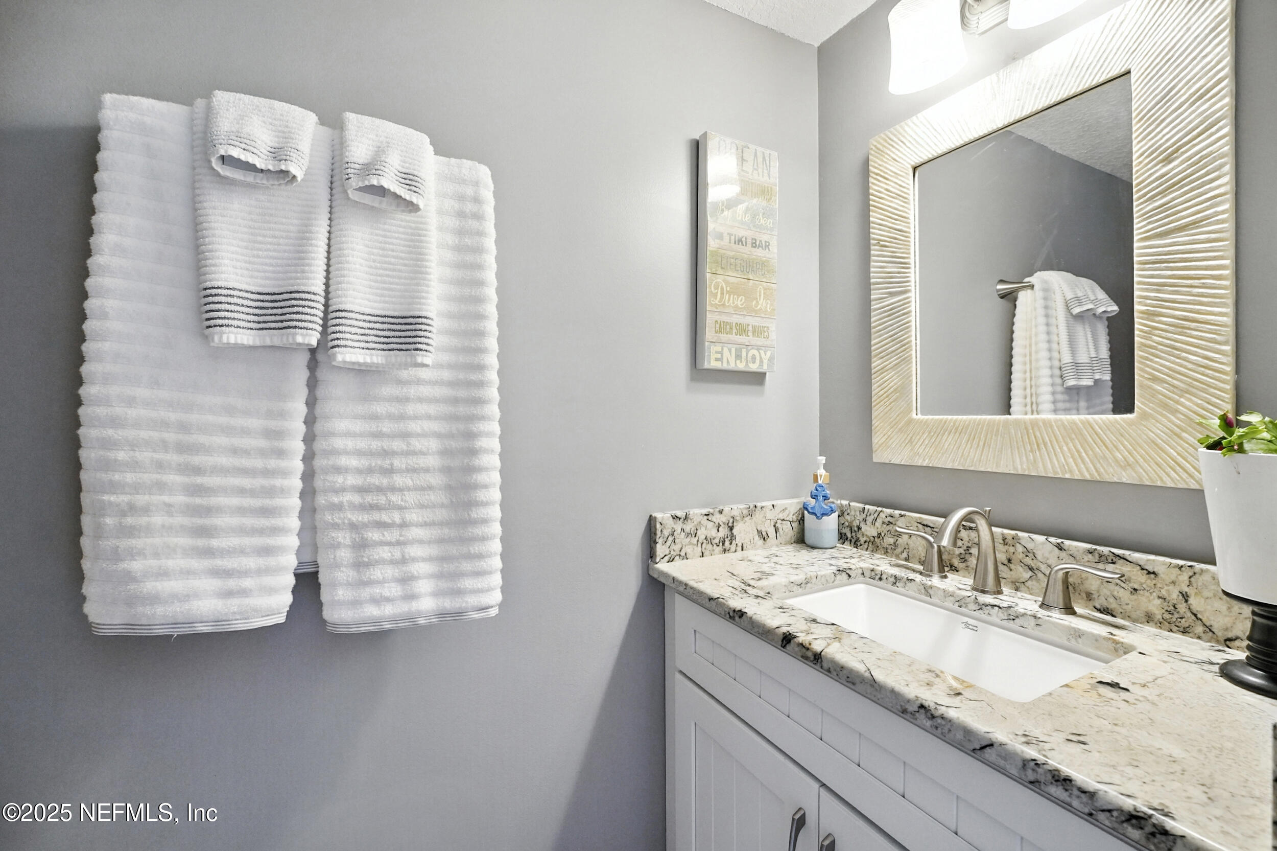 2233 Seminole Road, Unit 3 Atlantic Beach, FL 32233 - Photo 26 of 59 a bathroom with a granite countertop sink and a mirror