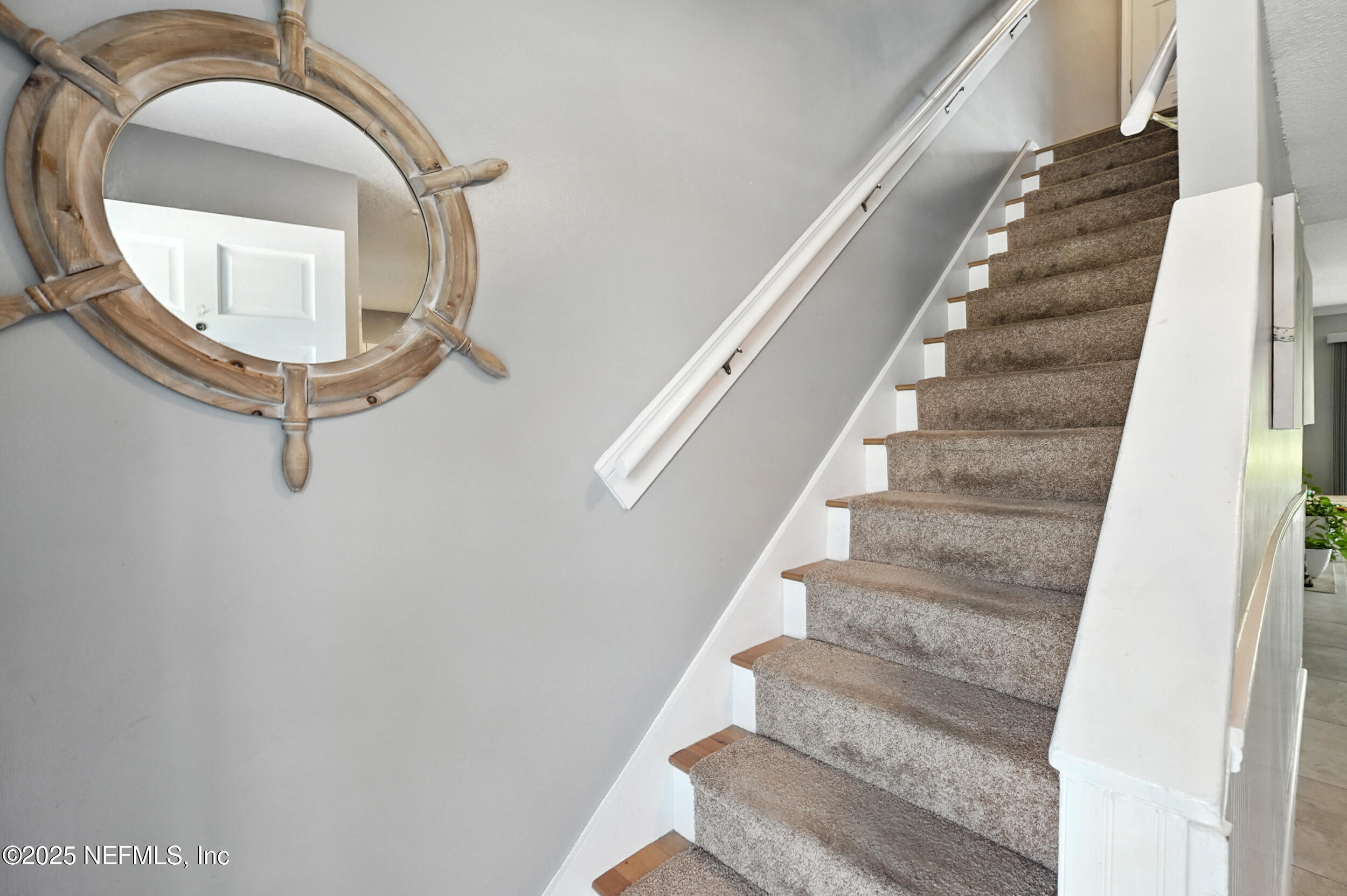 2233 Seminole Road, Unit 3 Atlantic Beach, FL 32233 - Photo 27 of 59 a view of staircase with white walls and a mirror