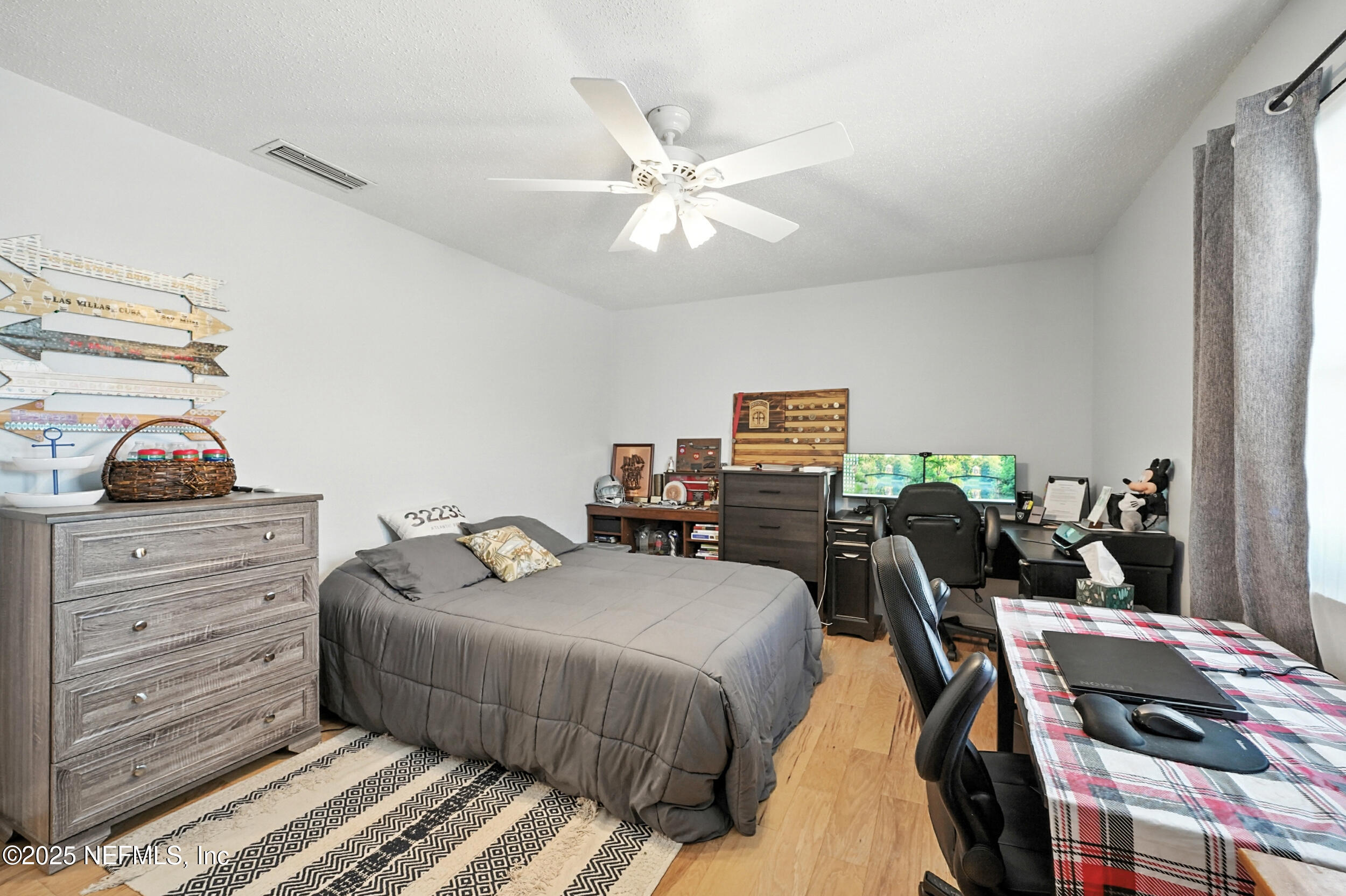 2233 Seminole Road, Unit 3 Atlantic Beach, FL 32233 - Photo 34 of 59 a bedroom with a bed and a chandelier