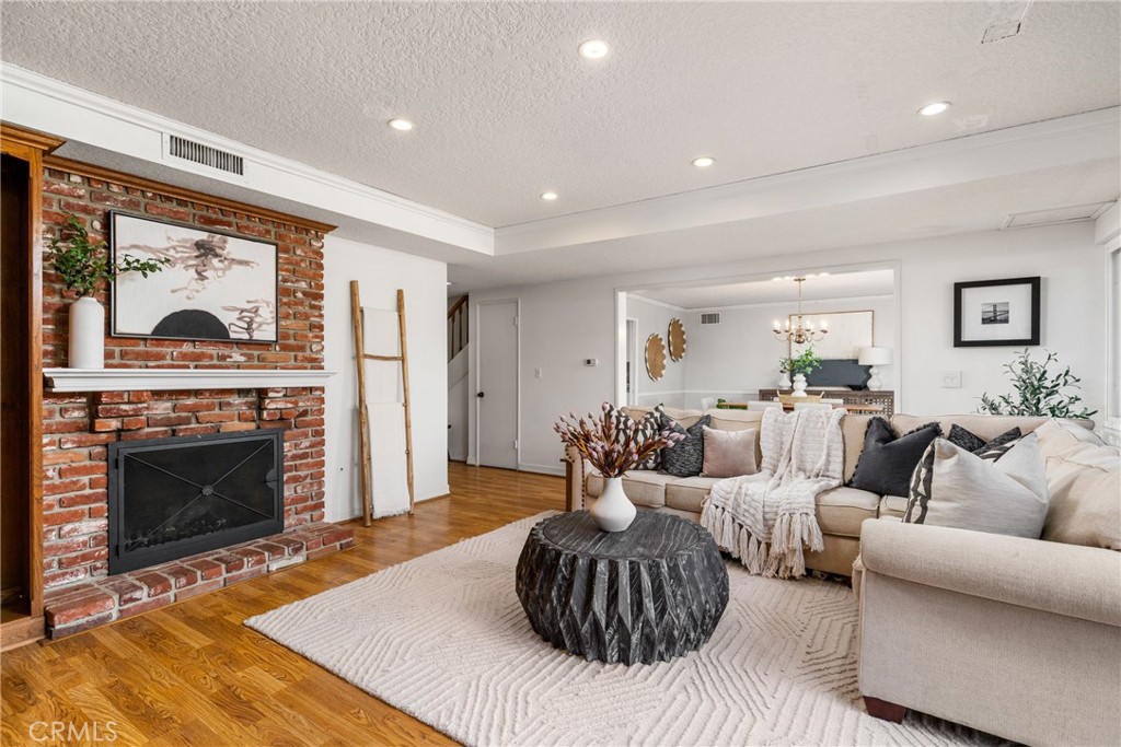 1856 Paros Circle Costa Mesa, CA 92626 - Photo 16 of 35 a living room with furniture a fireplace and a large window