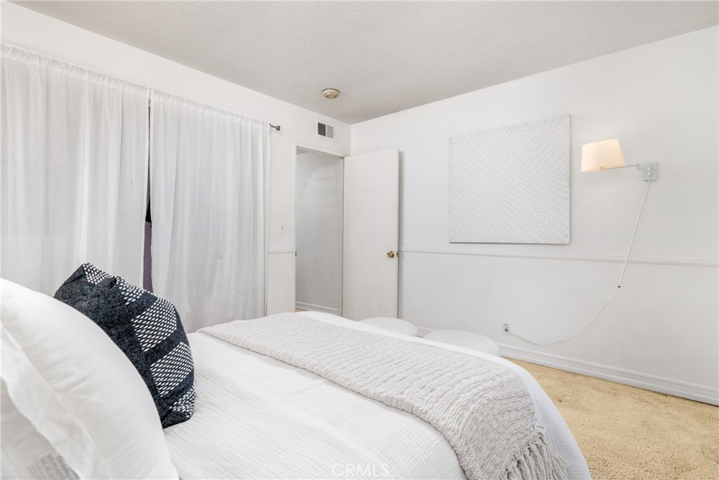 1856 Paros Circle Costa Mesa, CA 92626 - Photo 23 of 35 a bedroom with a bed and a window