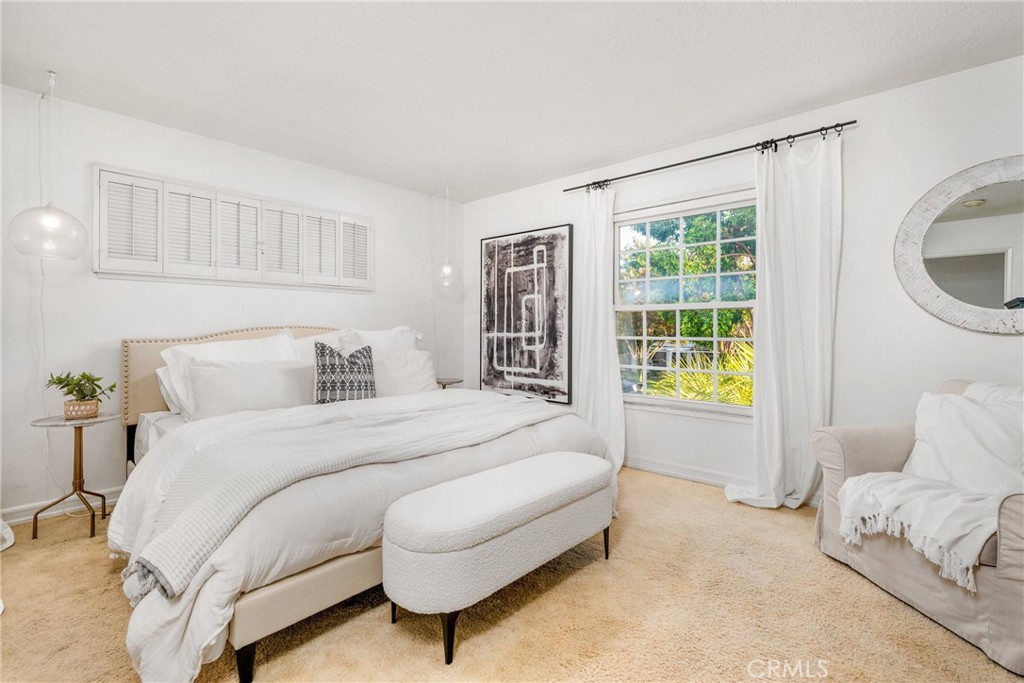 1856 Paros Circle Costa Mesa, CA 92626 - Photo 24 of 35 a spacious bedroom with a bed and a window