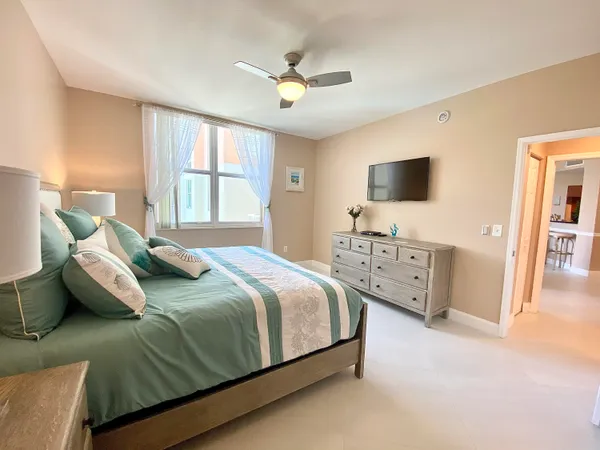 a bedroom with a bed and a flat screen tv