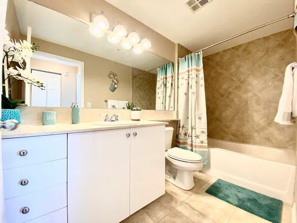 a bathroom with a sink toilet mirror and shower