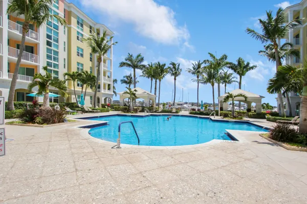 a view of swimming pool with outdoor seating and a tub