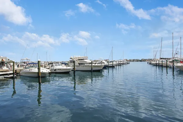 a view of water with boats and trees in the background