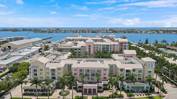 an aerial view of a city with ocean view in back