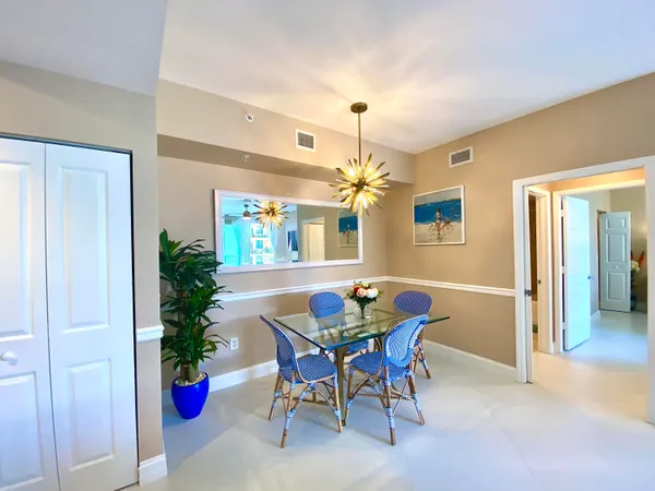 a view of a dining room with furniture and a potted plant