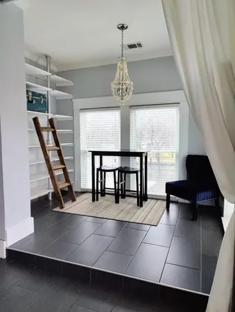 a view of a living room with furniture and a window