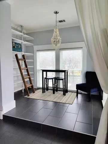 a view of a living room with furniture and a window