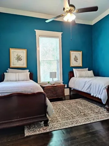 a bedroom with two beds and a window