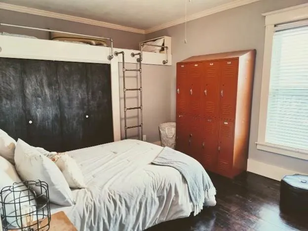 a bedroom with a bed and a window