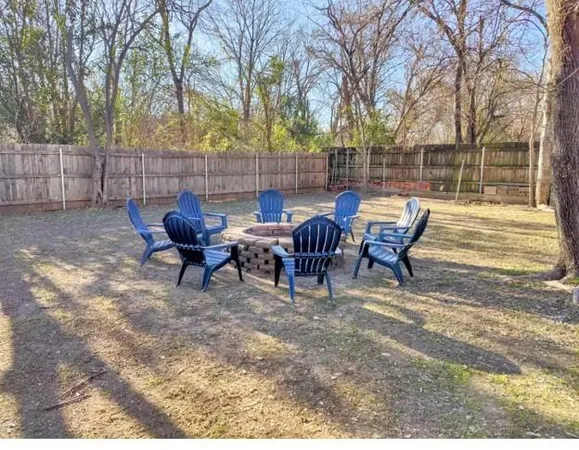 a view of a backyard with table and chairs