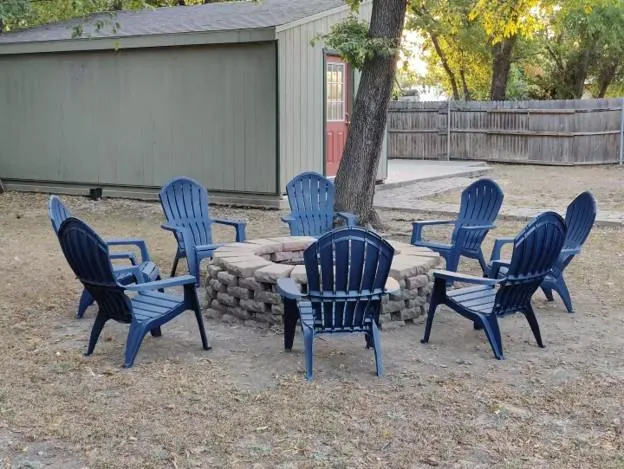 a view of a chairs and table in the back yard