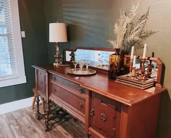 a kitchen with a stove and a wooden floor