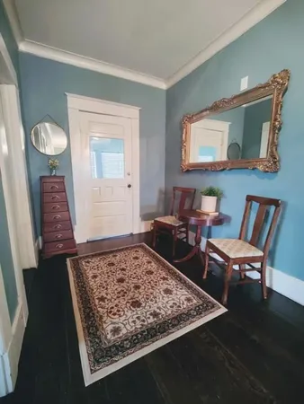 a living room with furniture and a rug