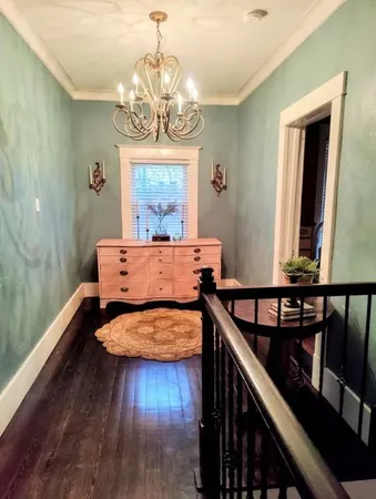 a bedroom with furniture and a chandelier