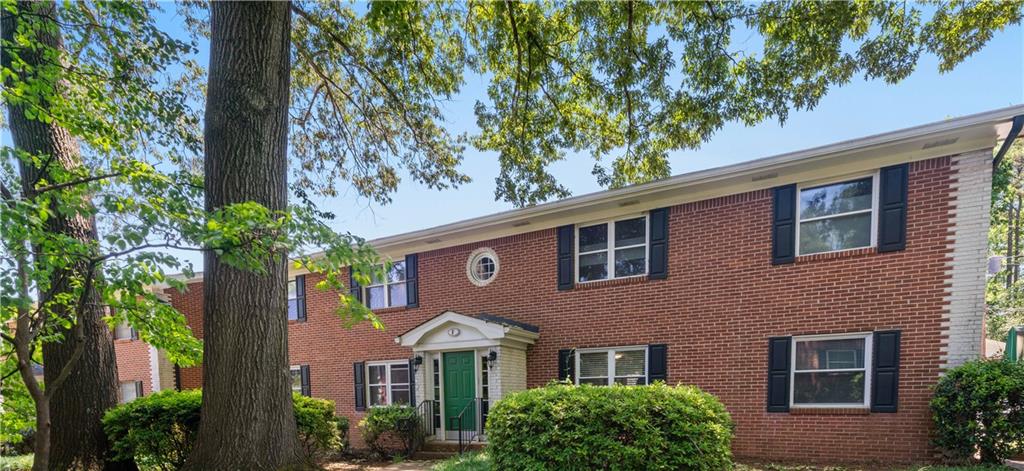 4282 Roswell Road, Unit F3 Atlanta, GA 30342 - Photo 1 of 1 a front view of a house with garden
