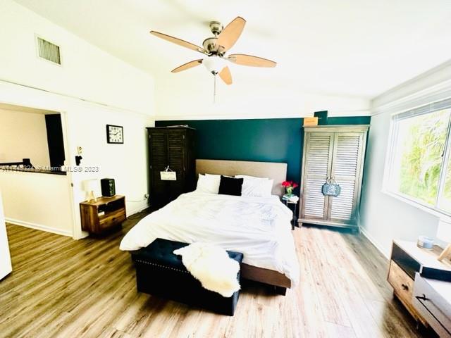 21108 Vía Eden Boca Raton, FL 33433 - Photo 26 of 48 a bedroom with a bed and wooden floor