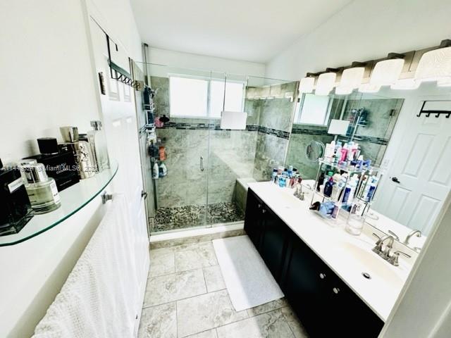 21108 Vía Eden Boca Raton, FL 33433 - Photo 27 of 48 a bathroom with a double vanity sink mirror and shower