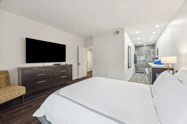 a bedroom with a bed and a flat screen tv