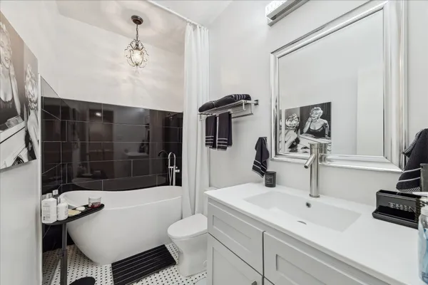 a bathroom with a sink toilet a mirror and shower