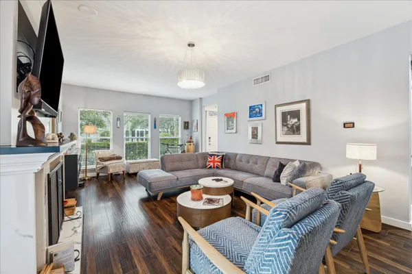 a living room with furniture a fireplace and a flat screen tv