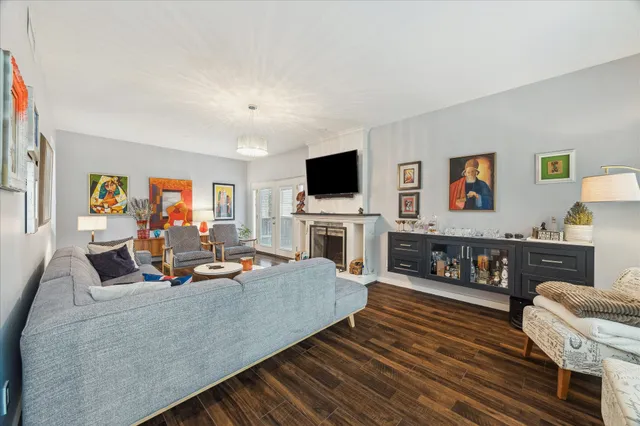a living room with fireplace furniture and a flat screen tv