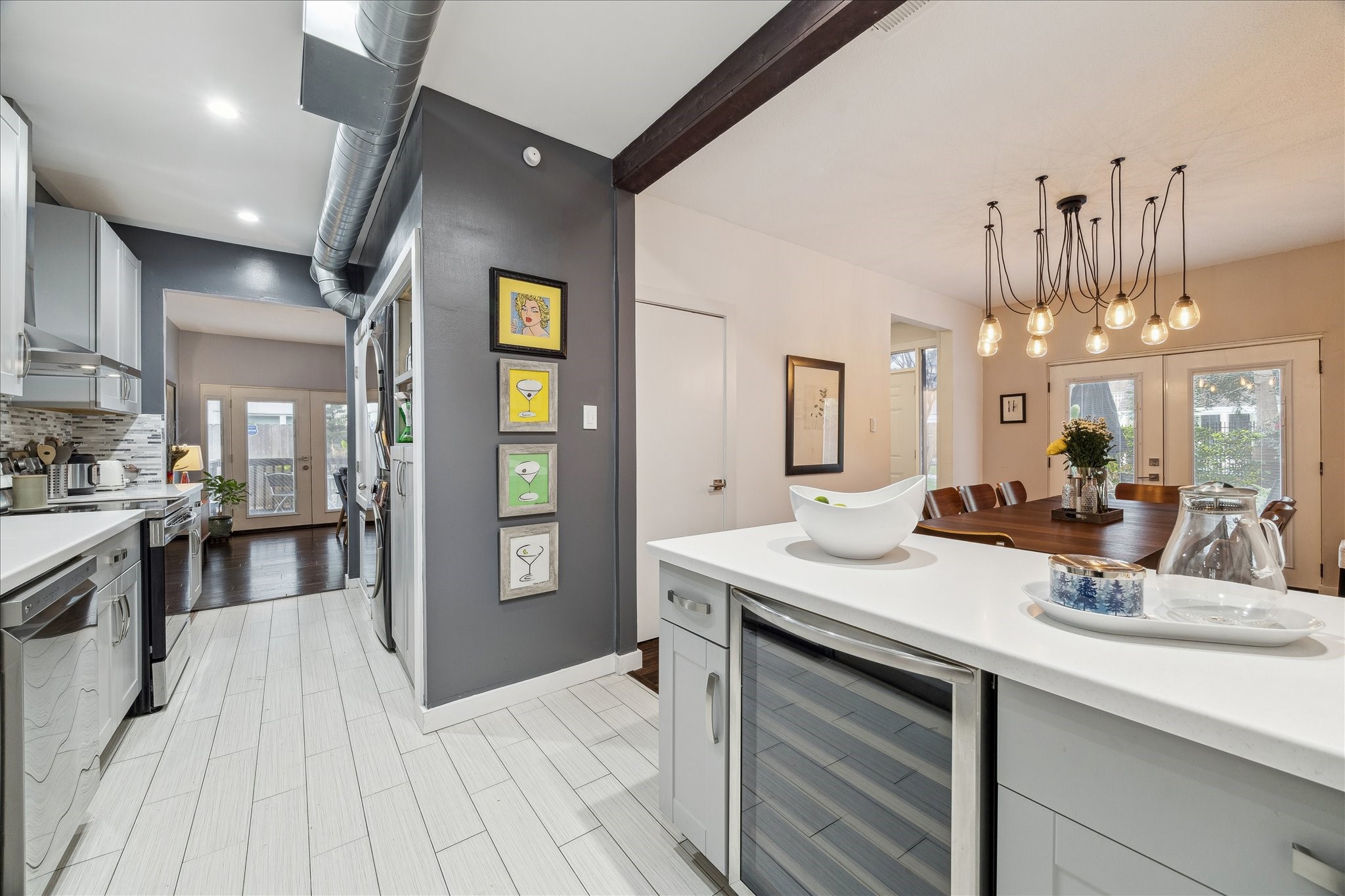 2100 Tanglewilde Street, Unit 373 Houston, TX 77063 - Photo 7 of 21 A kitchen island bar separates the dining area and features granite counters and a wine cooler