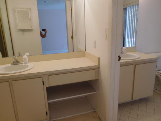 11504 Whisper Sound Drive Boca Raton, FL 33428 - Photo 15 of 32 a bathroom with a sink and a mirror