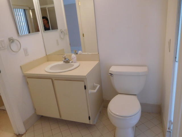 11504 Whisper Sound Drive Boca Raton, FL 33428 - Photo 16 of 32 a bathroom with a toilet sink and mirror