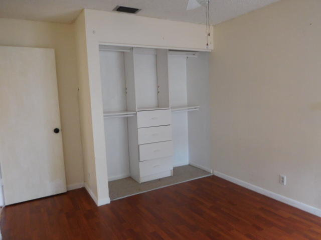 11504 Whisper Sound Drive Boca Raton, FL 33428 - Photo 19 of 32 an empty room with wooden floor