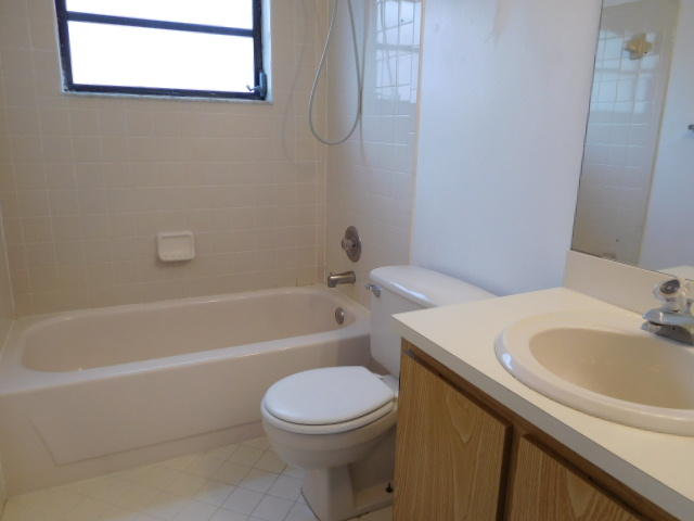 11504 Whisper Sound Drive Boca Raton, FL 33428 - Photo 20 of 32 a bathroom with a sink a toilet and a bathtub