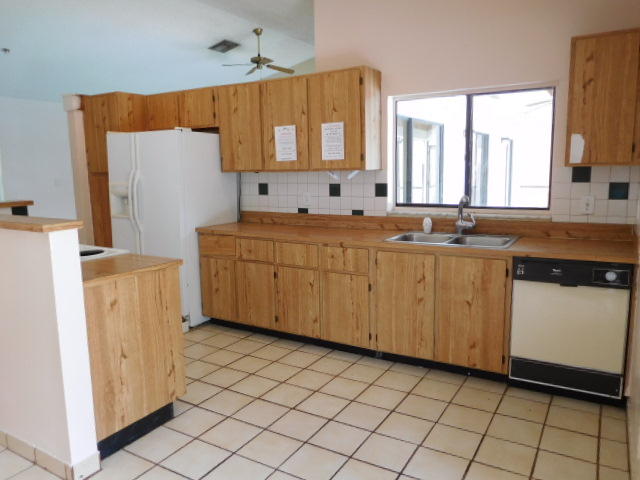 11504 Whisper Sound Drive Boca Raton, FL 33428 - Photo 28 of 32 a kitchen with a sink a refrigerator and window