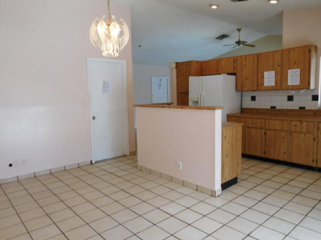 11504 Whisper Sound Drive Boca Raton, FL 33428 - Photo 29 of 32 a kitchen with cabinets and window