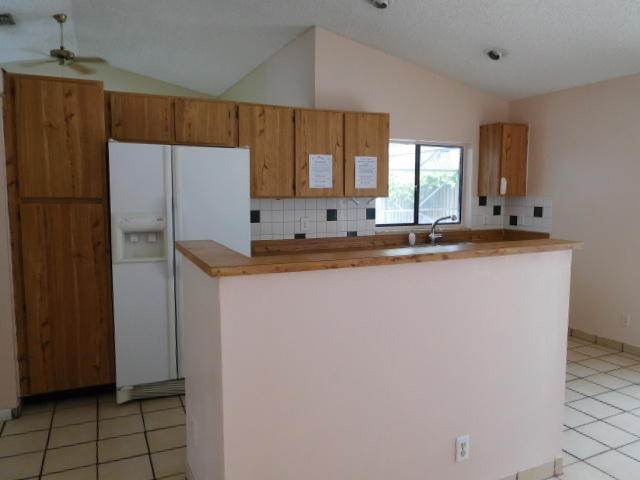 11504 Whisper Sound Drive Boca Raton, FL 33428 - Photo 8 of 32 a kitchen with stainless steel appliances granite countertop a refrigerator sink and cabinets