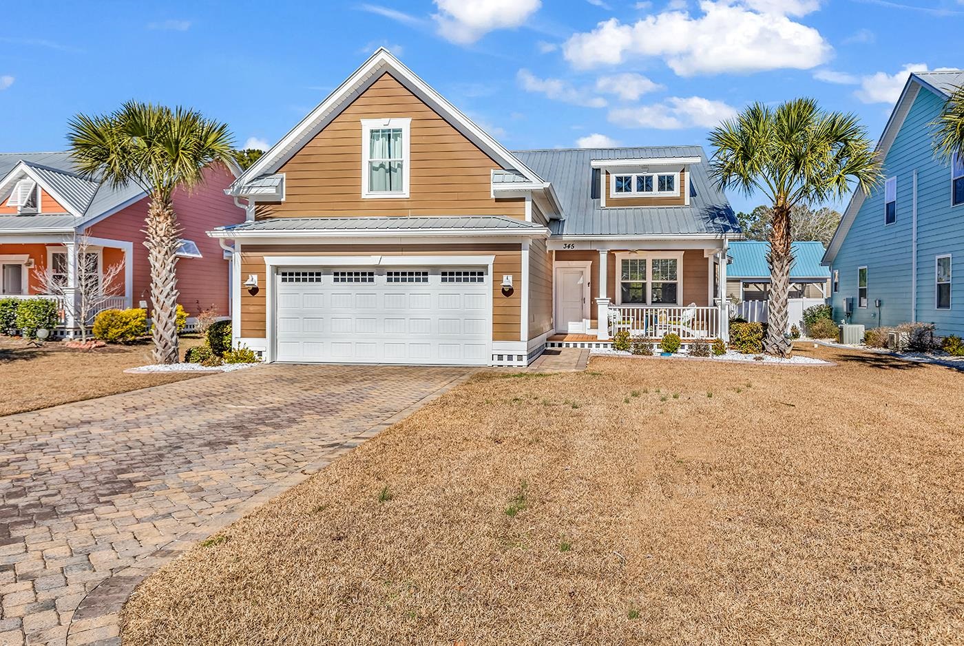 345 Waties Drive Murrells Inlet, SC 29576 - Photo 1 of 39 View of front of property featuring driveway, a garage, a metal roof, and a front yard
