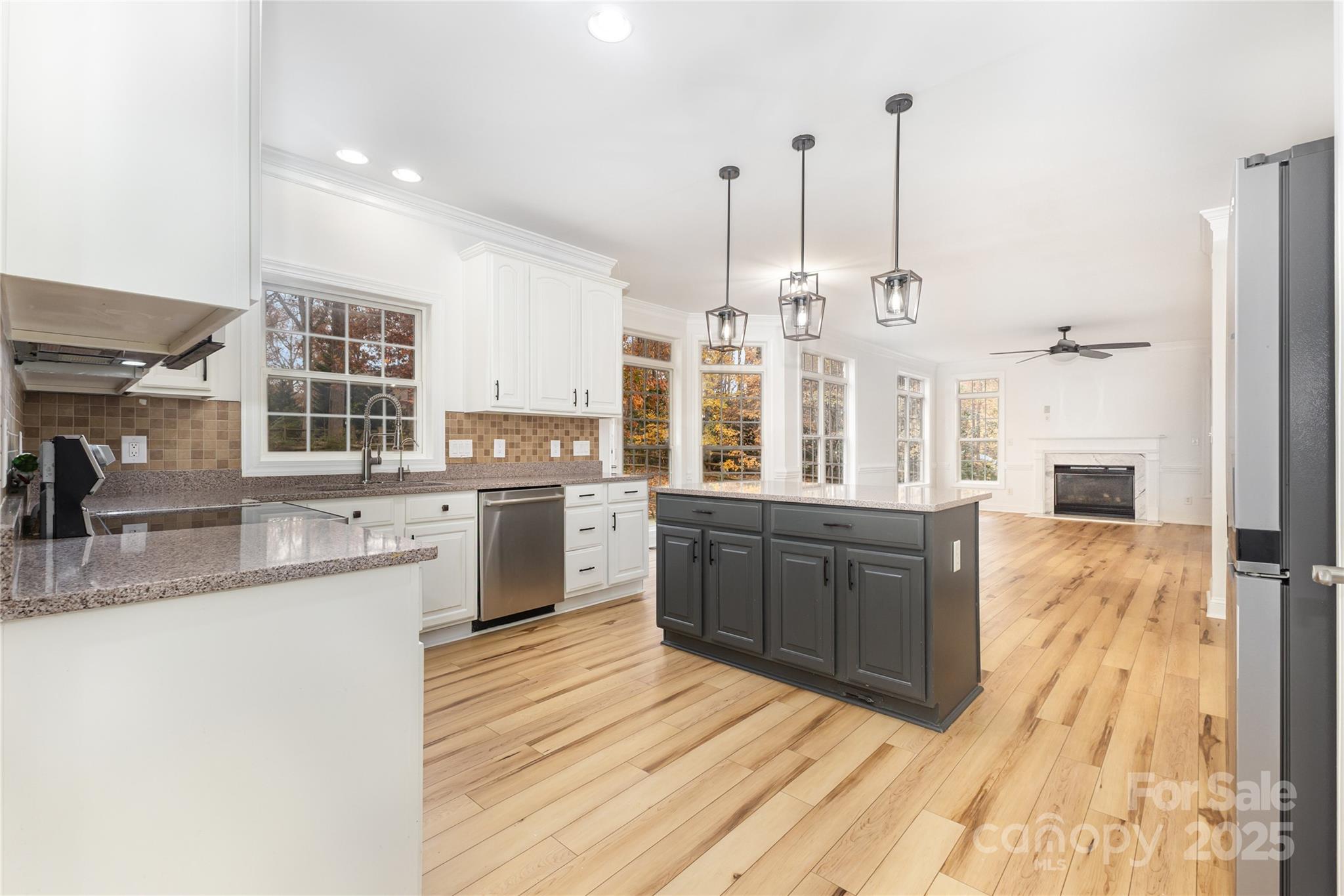 884 Clonmel Drive Matthews, NC 28104 - Photo 14 of 48 a large kitchen with kitchen island granite countertop a sink a counter space appliances and cabinets