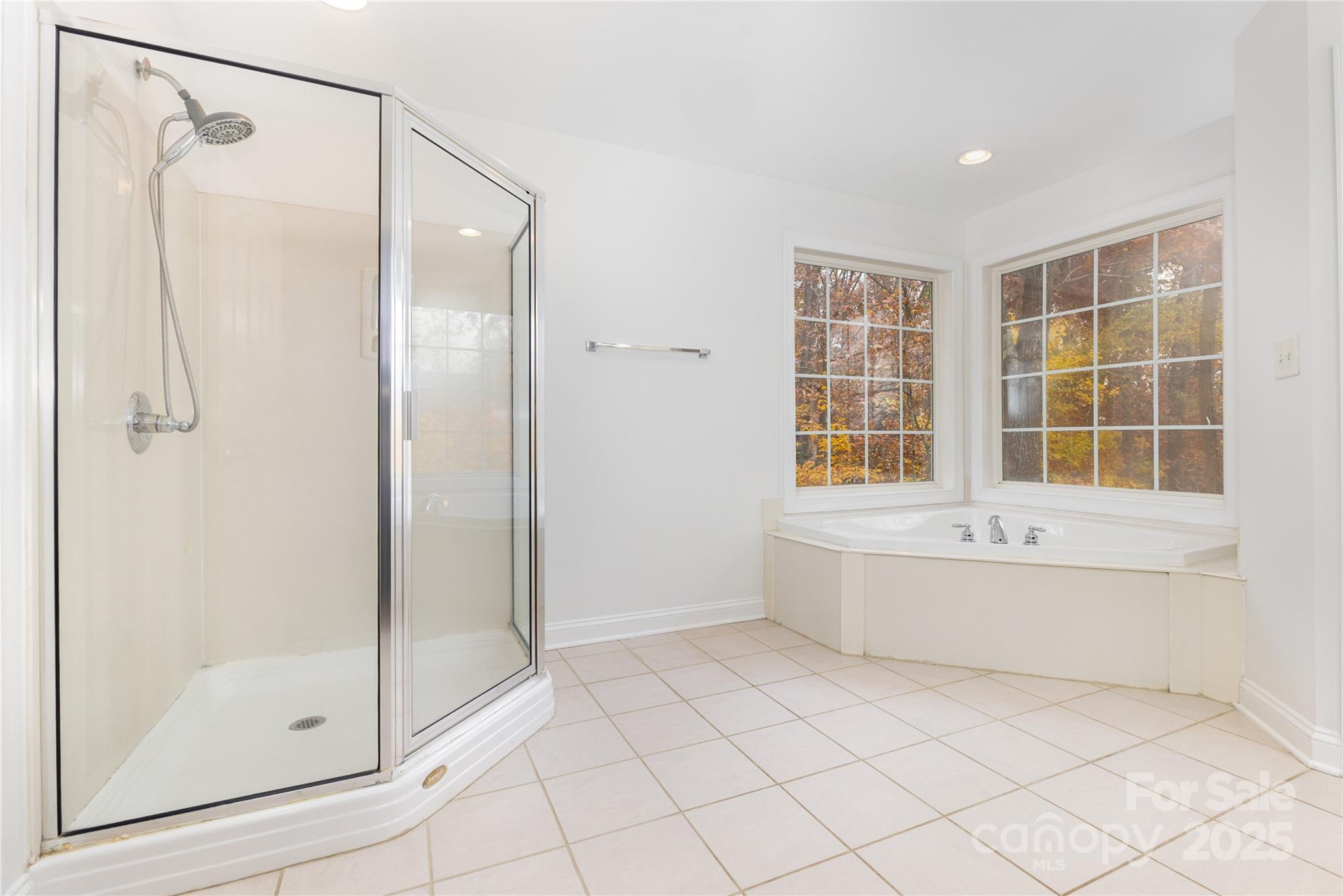 884 Clonmel Drive Matthews, NC 28104 - Photo 21 of 48 a spacious bathroom with a bathtub and a shower