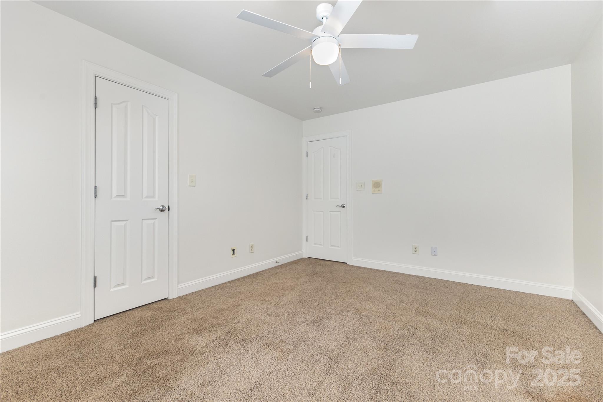 884 Clonmel Drive Matthews, NC 28104 - Photo 28 of 48 an empty room with a ceiling fan and a window