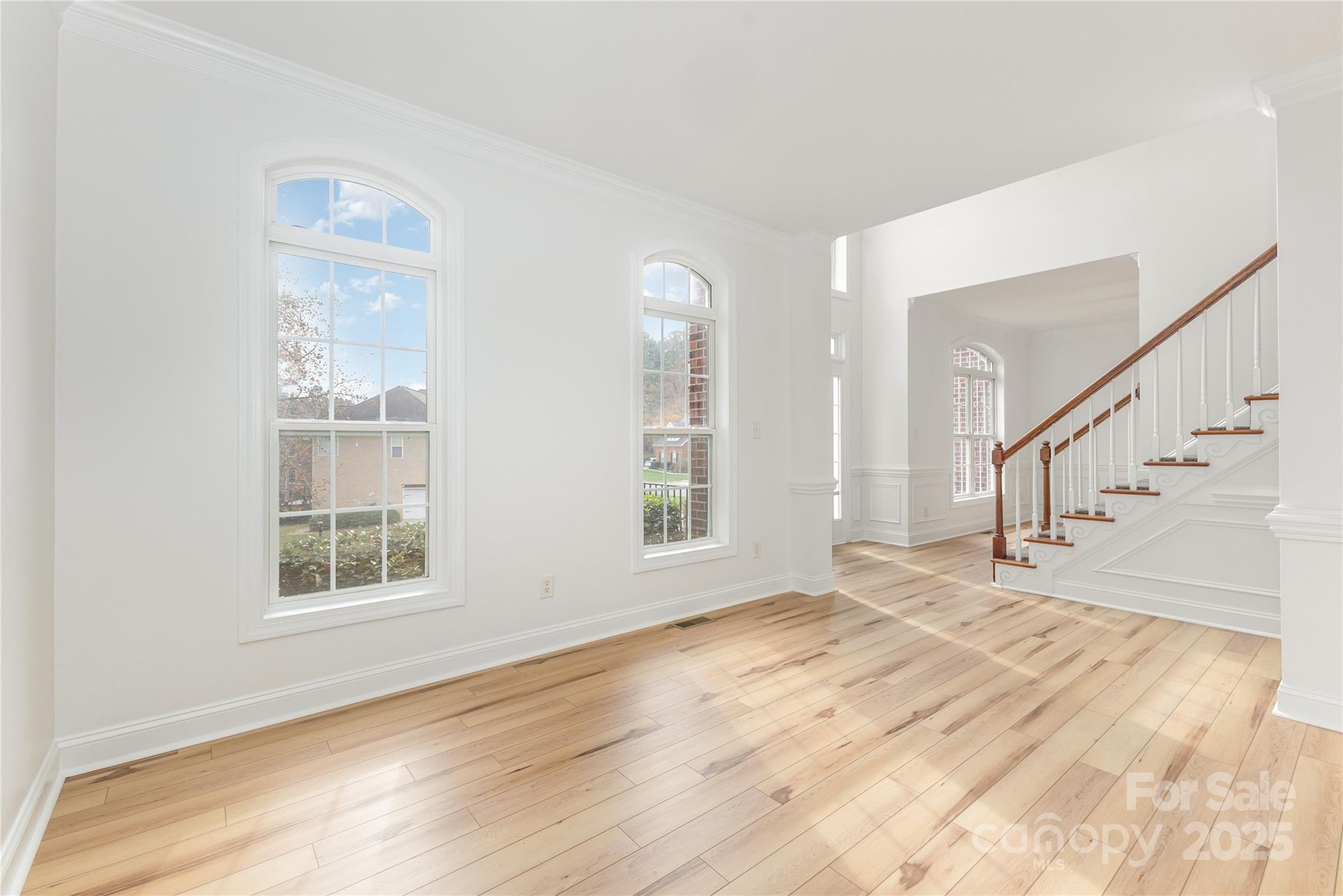 884 Clonmel Drive Matthews, NC 28104 - Photo 7 of 48 a view of an empty room with wooden floor and a window